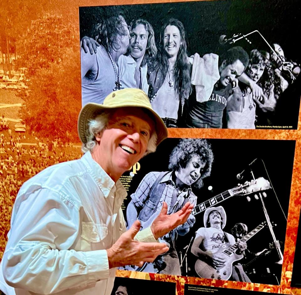 John Moran  poses with the exhibit “Return to Forever: Gainesville’s Great Southern Music Hall” at the Matheson History Museum in Gainesville. The Great Southern Music Hall was the top concert venue in Gainesville in the late 1970s. The exhibit showcases John Moran’s performance photos from his two years as the venue’s house photographer.