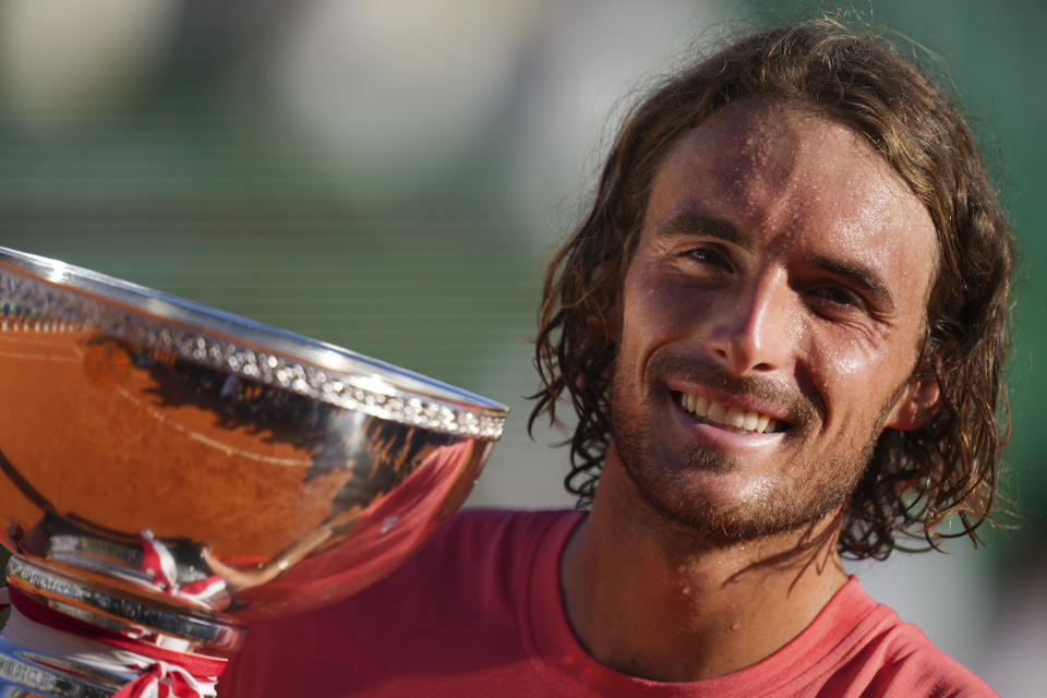 Stefanos Tsitsipas of Greece poses with the trophy after defeating Casper Ruud of Norway to win the Monte Carlo Tennis Masters final match 6-1, 6-4 in Monaco, Sunday, April 14, 2024. (AP Photo/Daniel Cole)