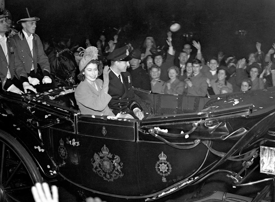 Princess Elizabeth and the Duke of Edinburgh in a carriage procession to Waterloo Station for their train to Winchester for the start of their honeymoon