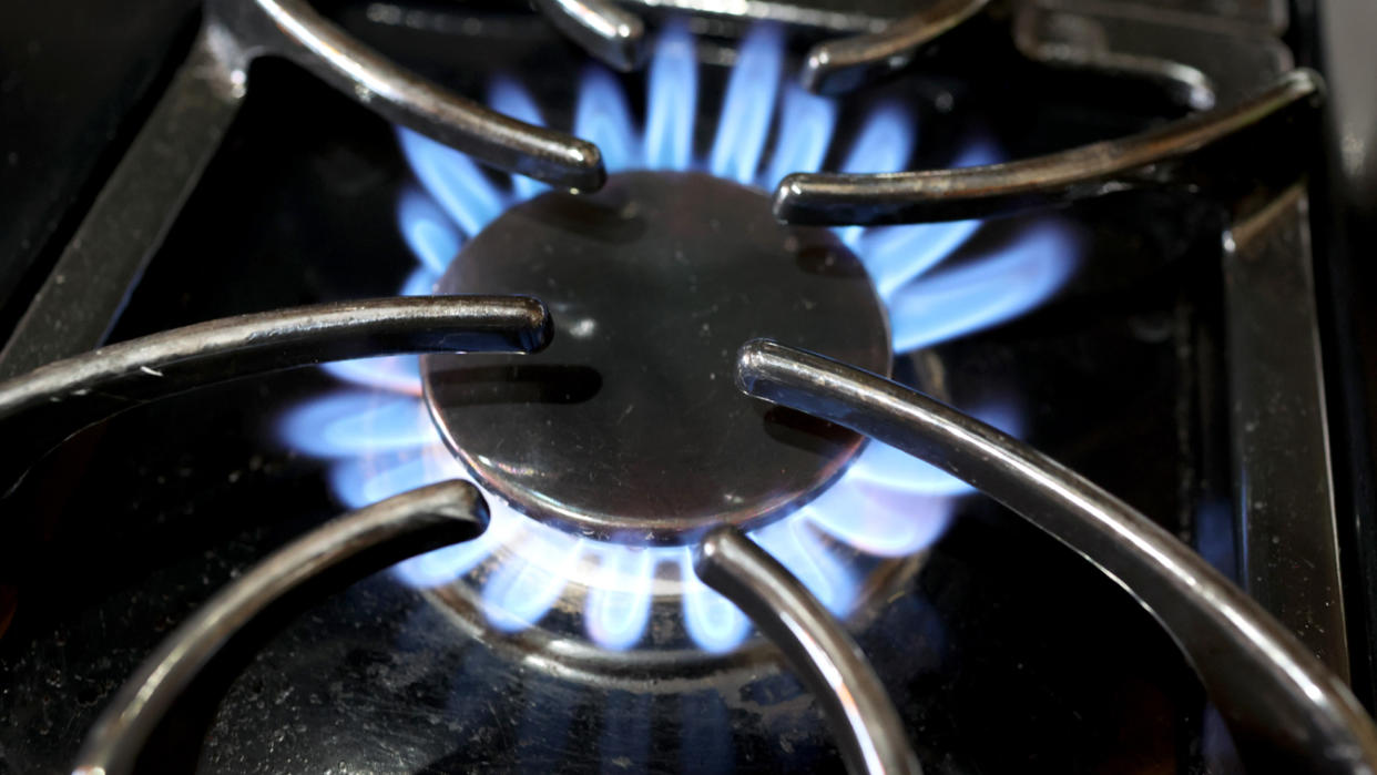 The flames of gas-burning stove that is turned on.