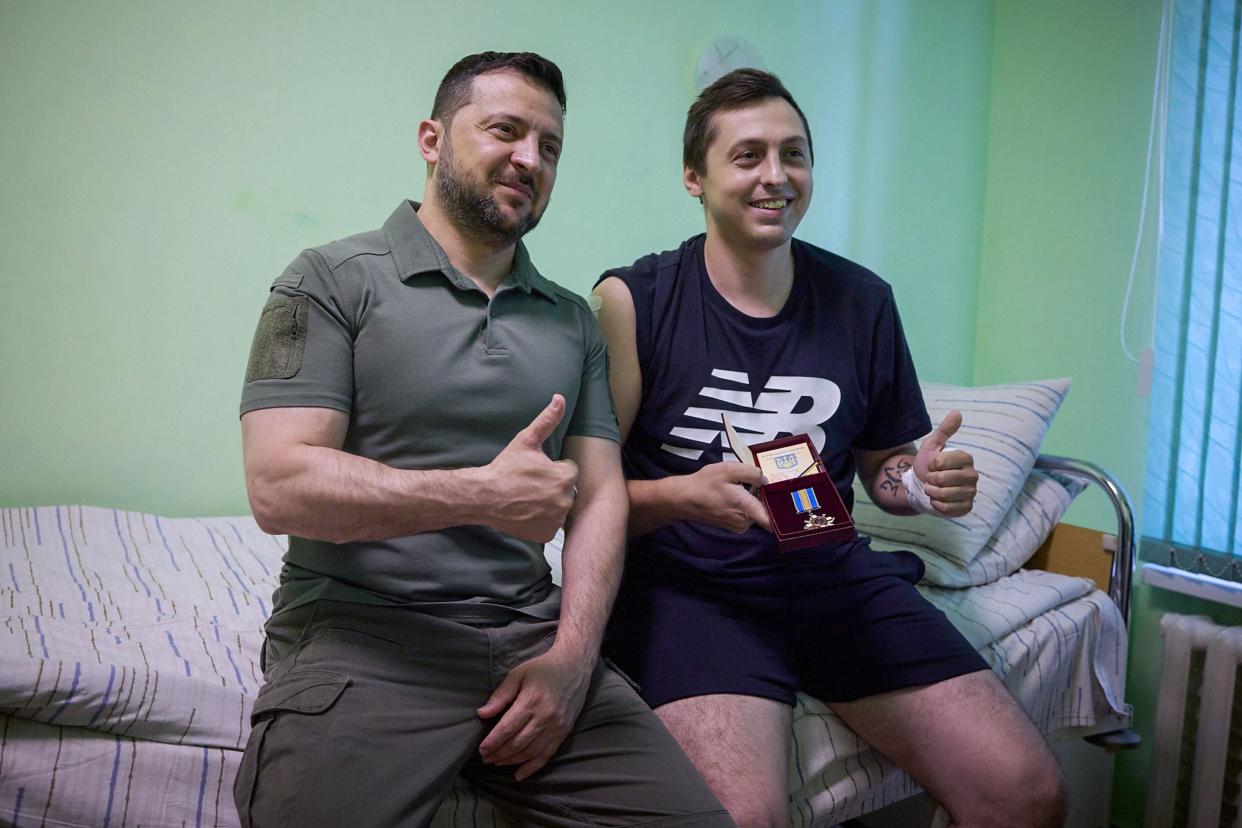 Ukraine's President Volodymyr Zelensky (L) posing for a photo with a serviceman of the Naval Forces of the Ukrainian Armed Forces at the military hospital in Odesa (Ukrainian Presidential Press Service)