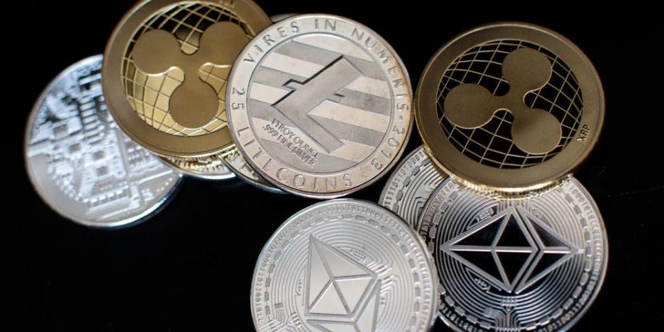In this photo illustration of the litecoin, ripple and ethereum cryptocurrency 'altcoins' sit arranged for a photograph
