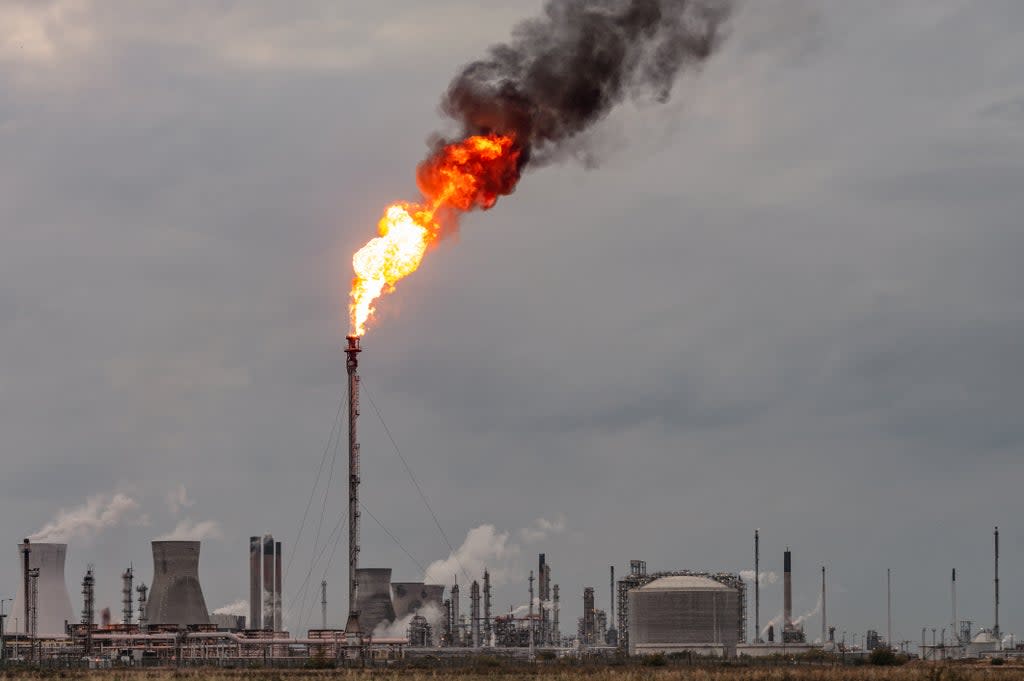 A large flame and dark smoke rising from a flare stack at Grangemouth oil refinery and petrochemical plant in Scotland (Getty)