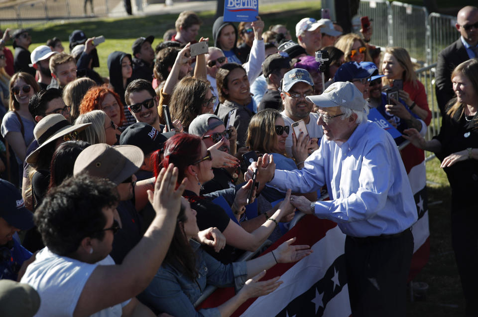 2020 Democratic presidential candidate Sen. Bernie Sanders, right, meets with supporters at a rally Saturday, March 16, 2019, in Henderson, Nev. (AP Photo/John Locher)