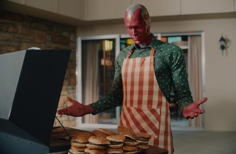 wearing an apron, Vision grills way too many burgers