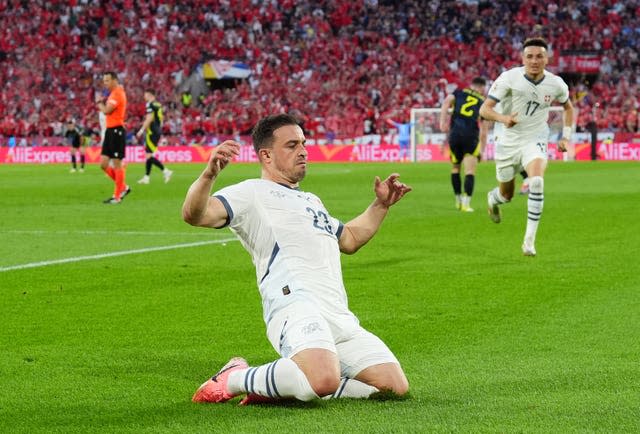 Xherdan Shaqiri slides on his knees to celebrate his equaliser