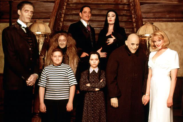 Everett Collection (From left to right) Carel Struycken, Jimmy Workman, Carol Kane, Raul Julia, Christina Ricci, Anjelica Huston, Christopher Lloyd, and Joan Cusack in 'Addams Family Values'