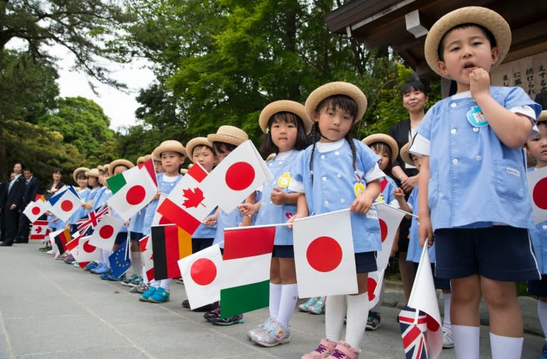 A group of school children wait for the G7 leaders to arrive for their tour of the Ise-Jingu Shrine in the city of Ise in Mie prefecture