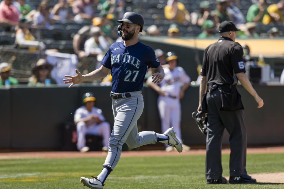 Seattle Mariners' Jesse Winker (27) reacts after scoring the go-ahead run against the Oakland Athletics during the ninth inning of a baseball game in Oakland, Calif., Thursday, June 23, 2022. (AP Photo/John Hefti)