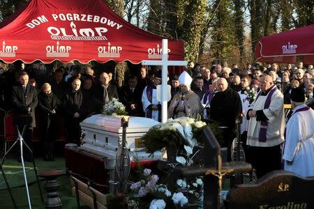 Relatives of the family and representatives of Polish authorities take part in the funeral of the Polish driver Lukasz Urban, who was killed in the Berlin Christmas market attack, at the cemetery in Banie village near Szczecin, north-western Poland December 30, 2016. Agencja Gazeta/Cezary Aszkielowicz/via REUTERS