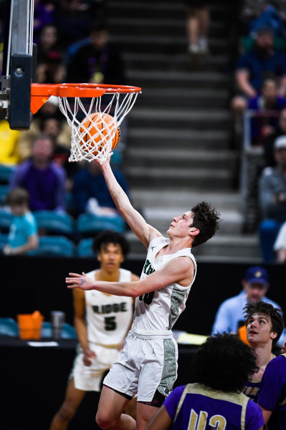 Fossil Ridge boys basketball player Ty Brown scores a layup during a 6A Great 8 game against Fort Collins at the Denver Coliseum on March 4.