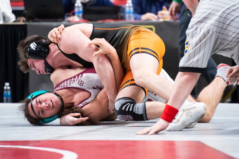 Central York's Macon Myers (top) works to pin Pottsville's Terrell Mcfarland at 2:24 during a 172-pound first round bout at the PIAA Class 3A Wrestling Championships at the Giant Center on March 9, 2023, in Derry Township.