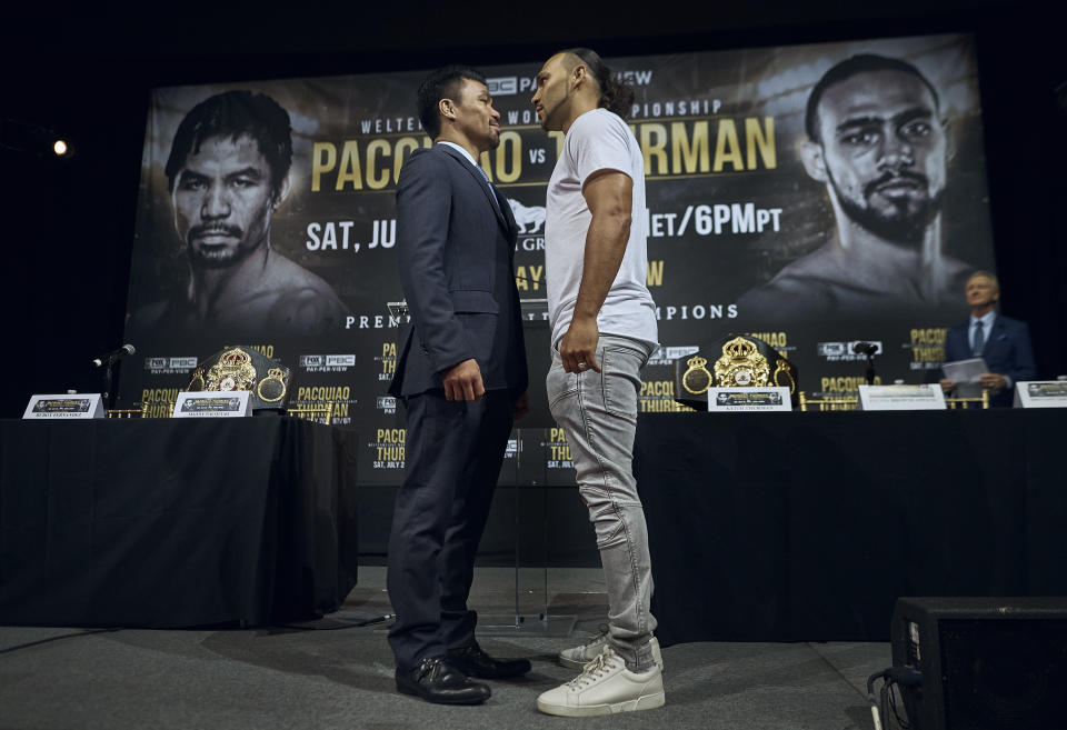 Manny Pacquiao, left, and Keith Thurman stand face to face during a news conference, Tuesday, May 21, 2019, in New York. The two are scheduled to fight in a welterweight world championship bout on Saturday, July 20, in Las Vegas. (AP Photo/Andres Kudacki)