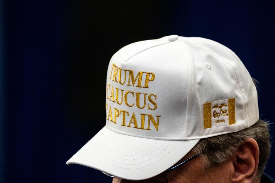 A Trump caucus captain wears a white caucus captain hat during a campaign rally at Waterloo Convention Center on Tuesday, Dec. 19, 2023, in Waterloo.