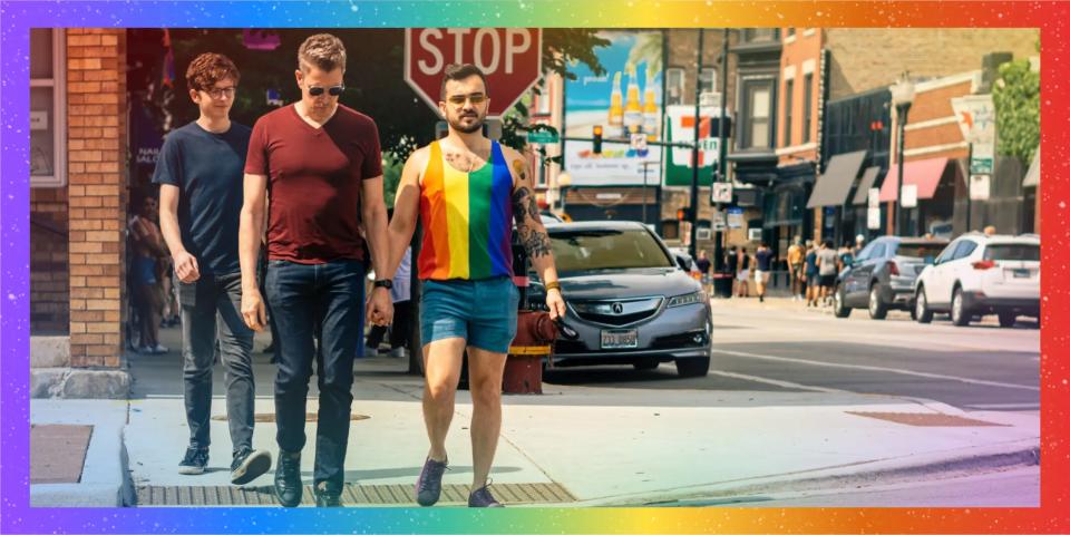 LGBTQ couple walking in Boystown with rainbow frame lead 2x1