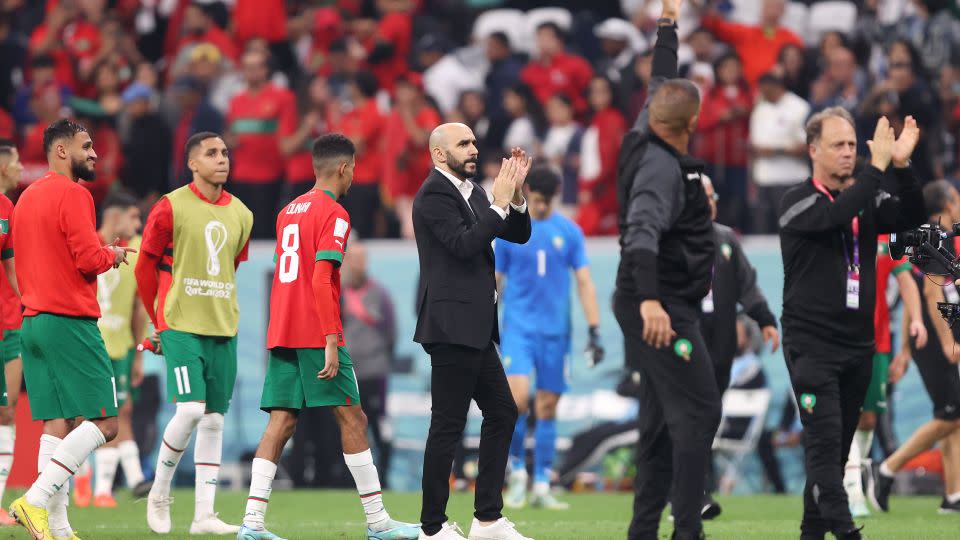 Regragui, center, applauds supporters after the team's 0-2 defeat to France in the semifinals of the 2022 FIFA World Cup in Qatar on December 14, 2022. - Julian Finney/Getty Images