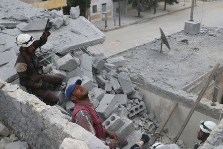 Civil defense members work at a site hit by an airstrike in the rebel held area of Aleppo's Baedeen district, Syria, May 3, 2016. REUTERS/Abdalrhman Ismail