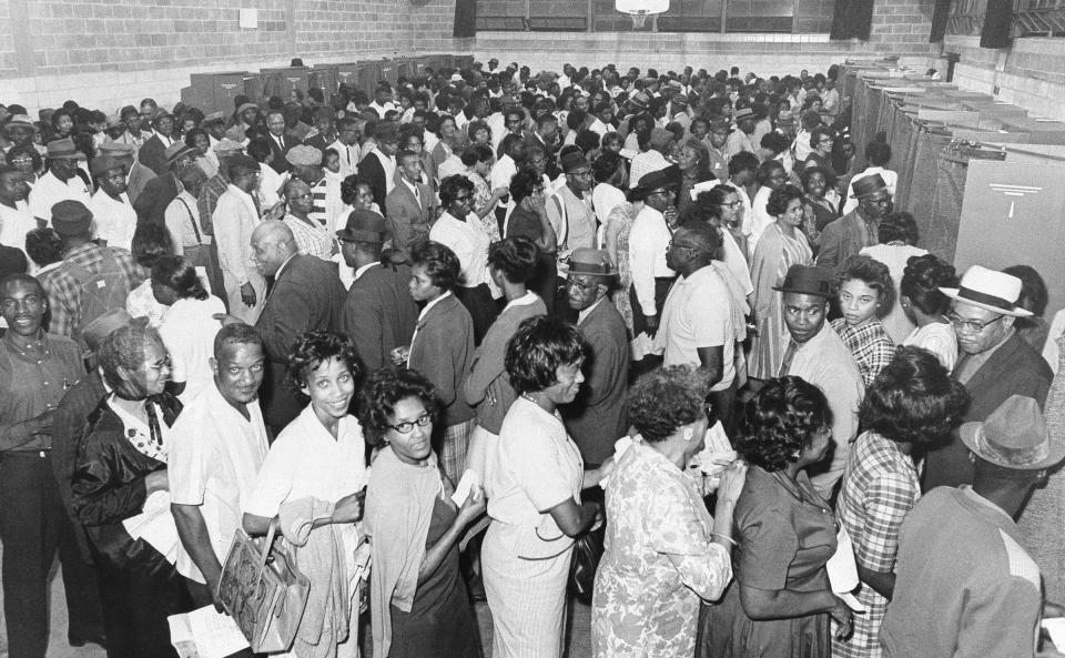 African Americans line up to vote after the passage of the Voting Rights Act in 1965