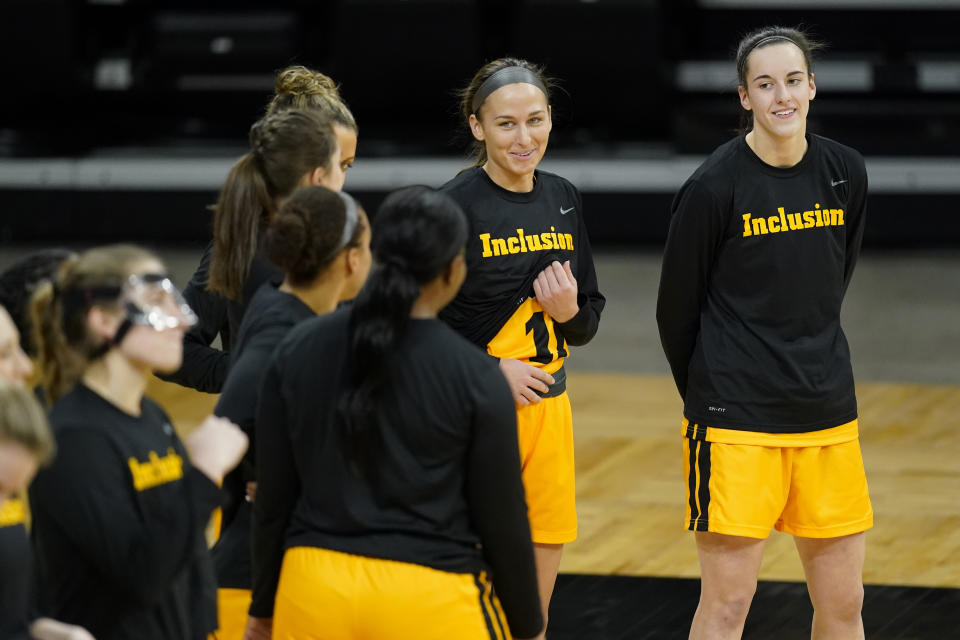 Iowa guard Caitlin Clark, right, laughs with teammates before an NCAA college basketball game against Ohio State, Wednesday, Jan. 13, 2021, in Iowa City, Iowa. Iowa Freshman Caitlin Clark is fourth in the nation in scoring at 25.6 points per game. (AP Photo/Charlie Neibergall)