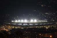 The San Paolo Stadium is illuminated to honor soccer legend and former Napoli player Diego Armando Maradona, in Naples, Italy, Wednesday, Nov. 25, 2020. Diego Maradona has died. The Argentine soccer great was among the best players ever and who led his country to the 1986 World Cup title before later struggling with cocaine use and obesity. He was 60. (AP Photo/Salvatore Laporta)