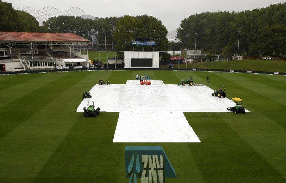 Protective covers lay on the pitch as play is delayed because of rain on the final day of the first cricket test at University Oval, Dunedin, New Zealand, Sunday, March 12, 2017. (AP Photo/Mark Baker)