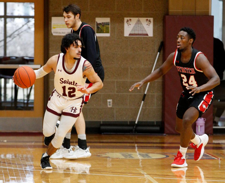 Phil Robles II (12) of the Holy Cross Saints men's basketball team, handles the ball against Cardinal Stritch University Jan. 15, 2023 in South Bend.
(Photo: Michael Wanbaugh, South Bend Tribune)