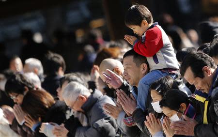 People offer prayers on the first day of the new year at Meiji Shrine in Tokyo