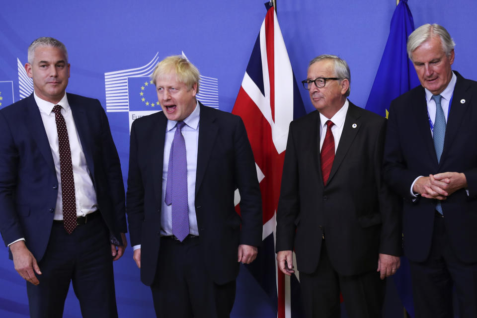 Britain's Brexit Secretary Stephen Barclay, British Prime Minister Boris Johnson, European Commission President Jean-Claude Juncker and European Union chief Brexit negotiator Michel Barnier, from left, pose for a photo during a press point at EU headquarters in Brussels, Thursday, Oct. 17, 2019. Britain and the European Union reached a new tentative Brexit deal on Thursday, hoping to finally escape the acrimony, divisions and frustration of their three-year divorce battle. (AP Photo/Francisco Seco)