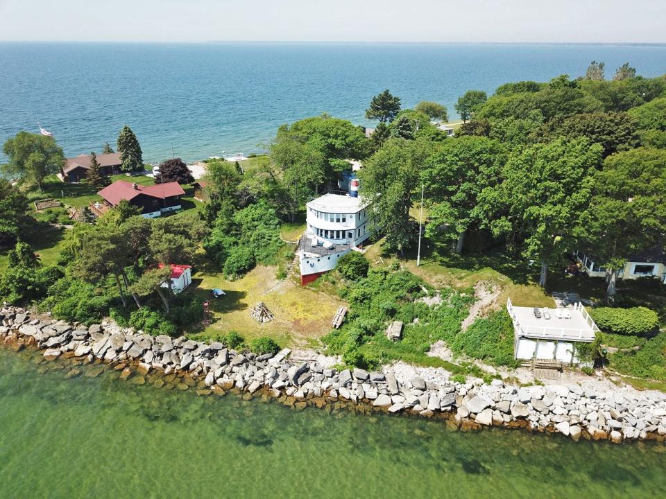 A wide shot of the house on the water.