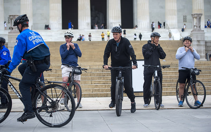 Kevin McCarthy is seen among others riding bikes in front of the Lincoln Memorial steps