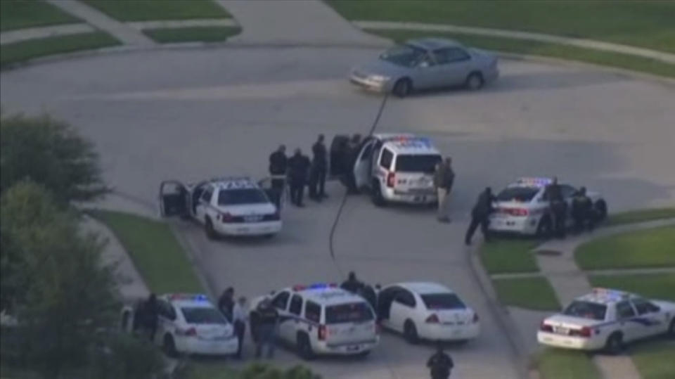 A still image taken from KPRC-TV aerial video footage shows police and a suspect in a standoff at a residential neighborhood following a shooting incident in Spring, Texas July 9, 2014. (REUTERS/KPRC-TV)