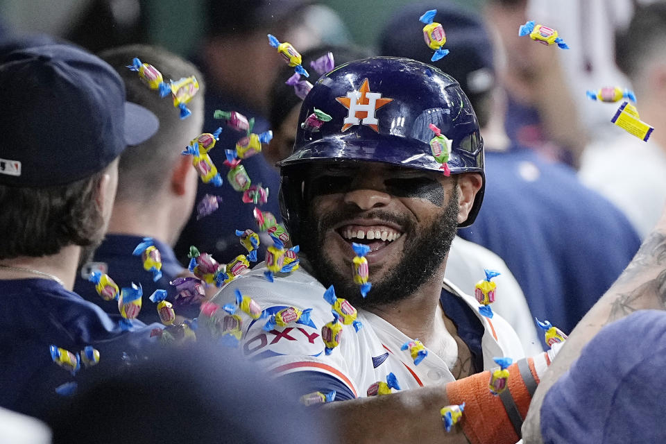 Houston Astros' Jon Singleton is congratulated in the dugout after hitting a go-ahead two-run home run during the seventh inning of a baseball game against the Seattle Mariners, Sunday, May 5, 2024, in Houston. (AP Photo/Kevin M. Cox)