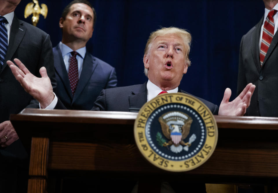 FILE - In this Oct. 19, 2018 file photo, President Donald Trump speaks during a ceremony to sign a "Presidential Memorandum Promoting the Reliable Supply and Delivery of Water in the West," Friday, Oct. 19, 2018, in Scottsdale, Ariz.. Standing behind the president is Rep. Devin Nunes, R-Calif. Trump is set to present one of the nation's highest civilian honors to Nunes(AP Photo/Carolyn Kaster)