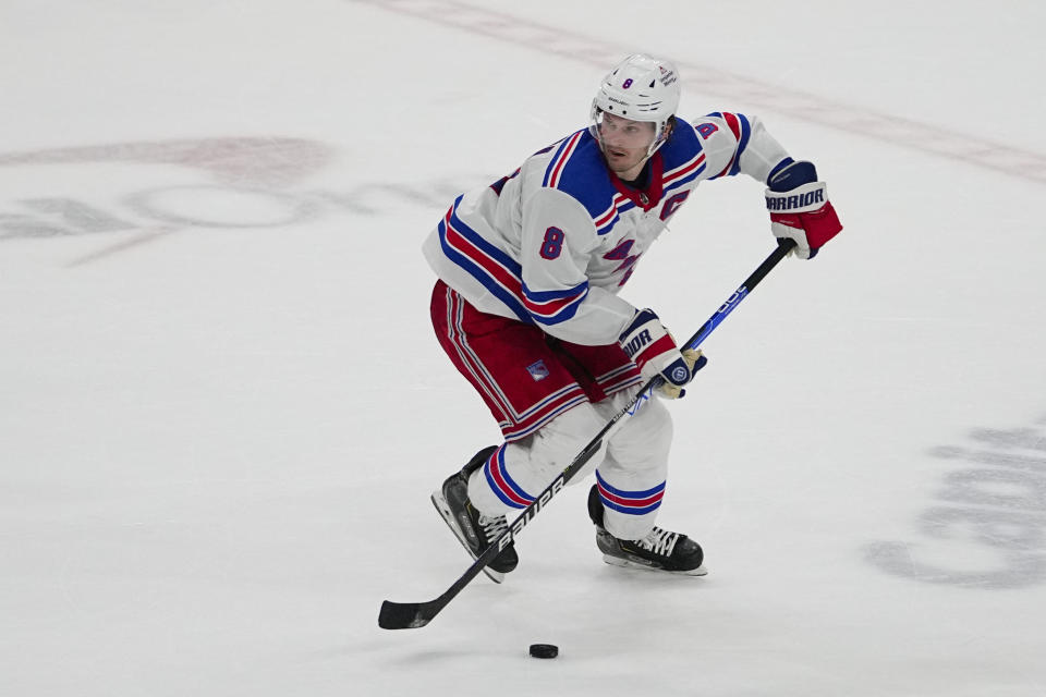 New York Rangers defenseman Jacob Trouba skates with the puck against the Washington Capitals during the second period of an NHL hockey game, Saturday, Feb. 25, 2023, in Washington. (AP Photo/Julio Cortez)