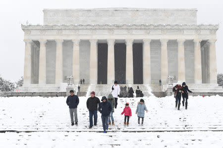 Visitors make their way through snow left by Winter Storm Gia, which paralyzed much of the nation's midsection, at the Lincoln Memorial in Washington, D.C., U.S., January 13, 2019. REUTERS/Mike Theiler