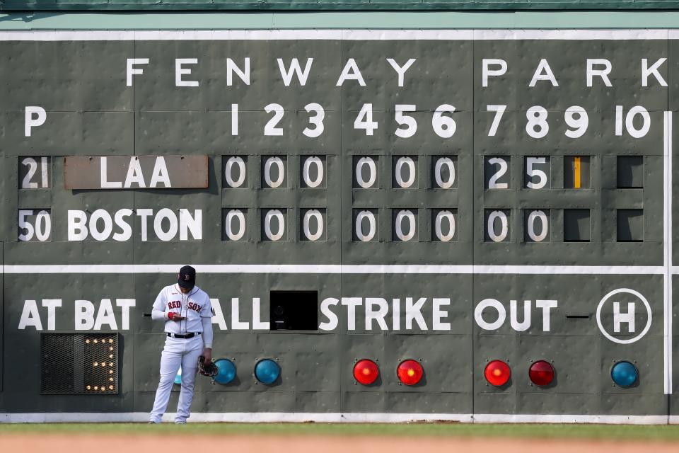 Boston Red Sox's Alex Verdugo stands in front of the scoreboard during the ninth inning of a baseball game against the Los Angeles Angels, Thursday, May 5, 2022, in Boston. (AP Photo/Michael Dwyer)