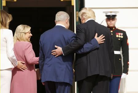 U.S. President Donald Trump (R) and first lady Melania Trump greet Israeli Prime Minister Benjamin Netanyahu and his wife Sara (2ndL) as they arrive at the South Portico of the White House in Washington, U.S., February 15, 2017. REUTERS/Kevin Lamarque