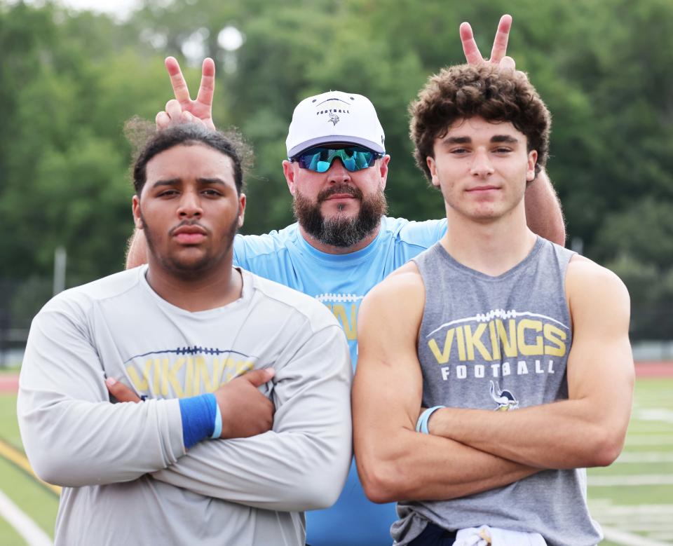 East Bridgewater co-captains Jeo PiresDePina, left,  Gage Williams, right, and head football coach Tim Graham after a scrimmage versus Whitman-Hanson on Saturday, August 27, 2022.