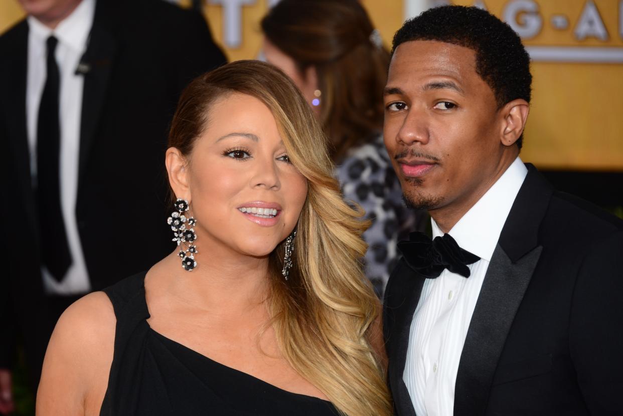 Singer Mariah Carey and husband and Nick Cannon attend the 20th annual Screen Actors Guild (SAG) Awards on January 18, 2014 at the Shrine Auditorium in Los Angeles.  AFP PHOTO / FREDERIC J. BROWN        (Photo credit should read FREDERIC J. BROWN/AFP via Getty Images)