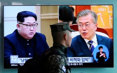 TV screen showing file footage of South Korean President Moon Jae-in and North Korean leader Kim Jong Un - Credit:  Ahn Young-joon/AP