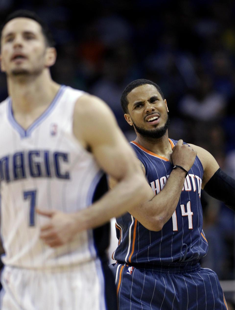 Charlotte Bobcats' D.J. Augustin (14) reacts after missing a shot as he chases Orlando Magic's J.J. Redick (7) downcourt during the second half of an NBA basketball game, Wednesday, April 25, 2012, in Orlando, Fla. Orlando won 102-95. (AP Photo/John Raoux)