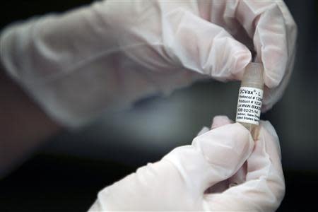 A manufacturing associate holds a vial with a DCVax-L label in a Northwest Biotherapeutics laboratory in Memphis, Tennessee in this file photo taken February 21, 2014. REUTERS/Mike Brown/Files