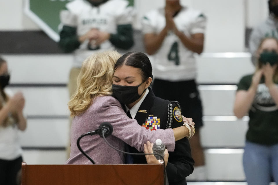 Jazlyn Ballman, center right, hugs U.S. first lady Jill Biden during a visit to Naples Middle High School, a Department of Defense Education Activity (DoDEA) school, after attending events on the sidelines of the G20 summit in Rome, Monday, Nov. 1, 2021. (AP Photo/Alessandra Tarantino)