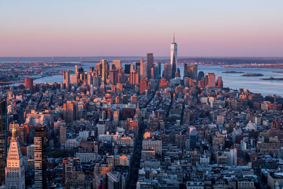 TOPSHOT - The Manhattan skyline is seen at sunrise from the 86th floor observatory of the Empire State Building on April 3, 2021, in New York City. - The Empire State Building, a 102-story Art Deco skyscraper in Midtown Manhattan, opened during the Great Depression on May 1, 1931. / Credit: ANGELA WEISS/AFP via Getty Images