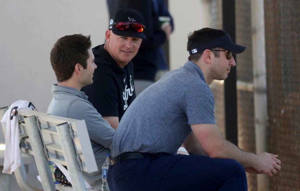 Tigers manager A.J. Hinch, center, talks with president of baseball operations Scott Harris, left, and assistant general manager Sam Menzin, right, during spring training on Monday, Feb. 20, 2023, in Lakeland, Florida.