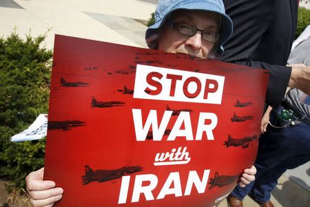 An activist holds a banner during an event of delivering more than 400,000 petition signatures to Capitol Hill in support of the Iran nuclear deal in Washington July 29, 2015. REUTERS/Yuri Gripas