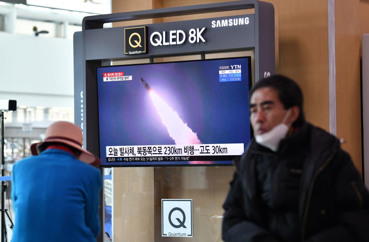 People watch a news broadcast showing file footage of a North Korean missile test, at a railway station in Seoul on March 29, 2020. - North Korea fired what appeared to be two short-range ballistic missiles off its east coast on March 29, the fourth such launch this month as the world battles the coronavirus pandemic. (Photo by Jung Yeon-je / AFP) (Photo by JUNG YEON-JE/AFP via Getty Images)