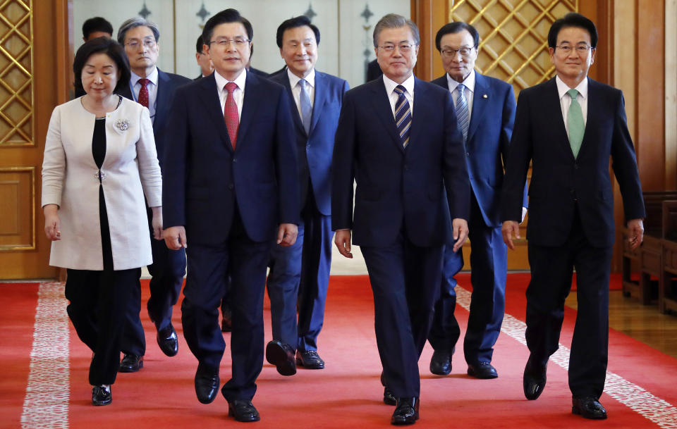 South Korean President Moon Jae-in, third from right, walks with ruling and opposition party leaders to attend a meeting to talk about an ongoing South Korea-Japan trade conflict at the presidential Blue House in Seoul, South Korea, Thursday, July 18, 2019. (Bee Jae-man/Yonhap via AP)