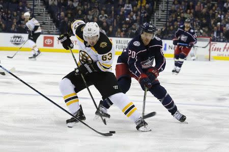 Mar 12, 2019; Columbus, OH, USA; Boston Bruins left wing Brad Marchand (63) skates with the puck as Columbus Blue Jackets center Riley Nash (20) trails the play during the third period at Nationwide Arena. Mandatory Credit: Russell LaBounty-USA TODAY Sports