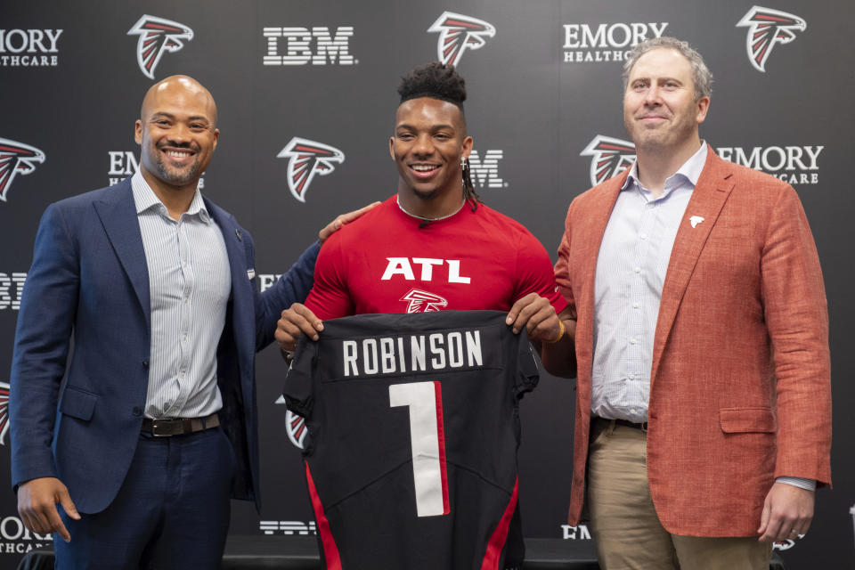Atlanta Falcons General Manager Terry Fontenot, from left, first round draft pick Bijan Robinson and head coach Arthur Smith pose for a photo before an NFL football press conference at the team's training facility in Flowery Branch, Ga., on Friday, April 28, 2023. (AP Photo/Ben Gray)